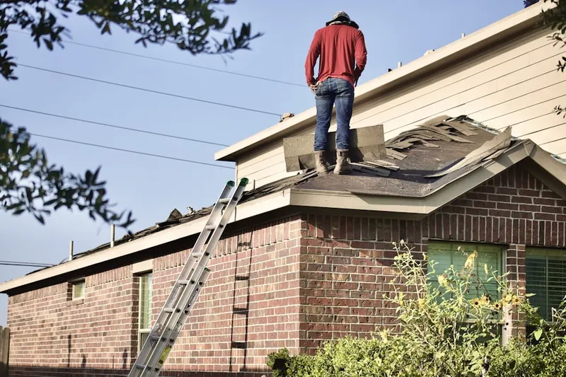 Professional roofer working on a residential roof in Hoppenville